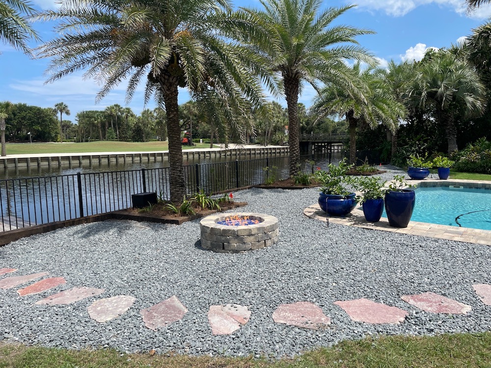 pool landscaping ideas in Florida with a stone walkway and a pool fence