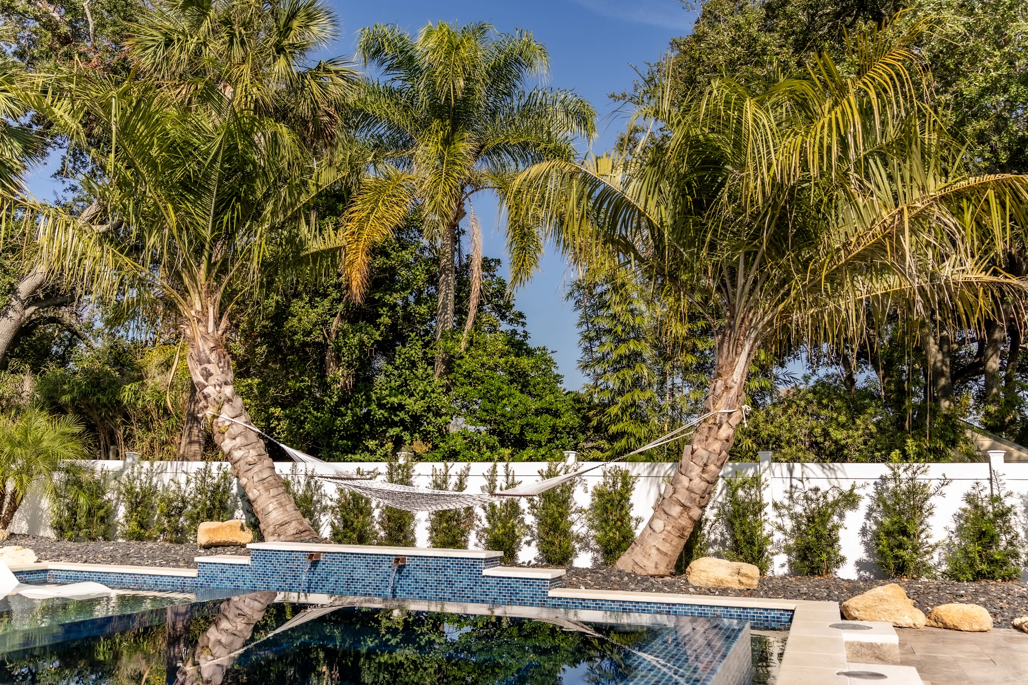 Luxury Coastal Patio Luxury paver patio design in Jacksonville Beach with coastal greenery and outdoor seating