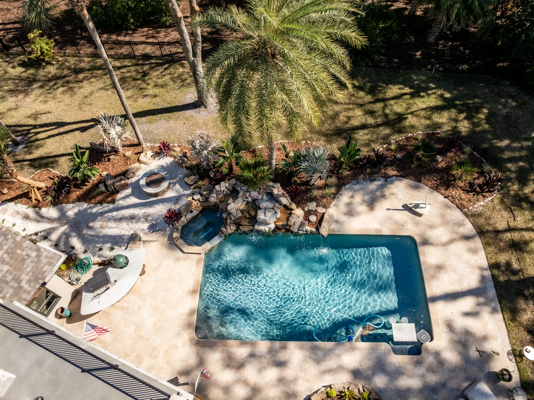 Backyard entertainment space Backyard entertainment space with outdoor kitchen, palms, and modern landscape design