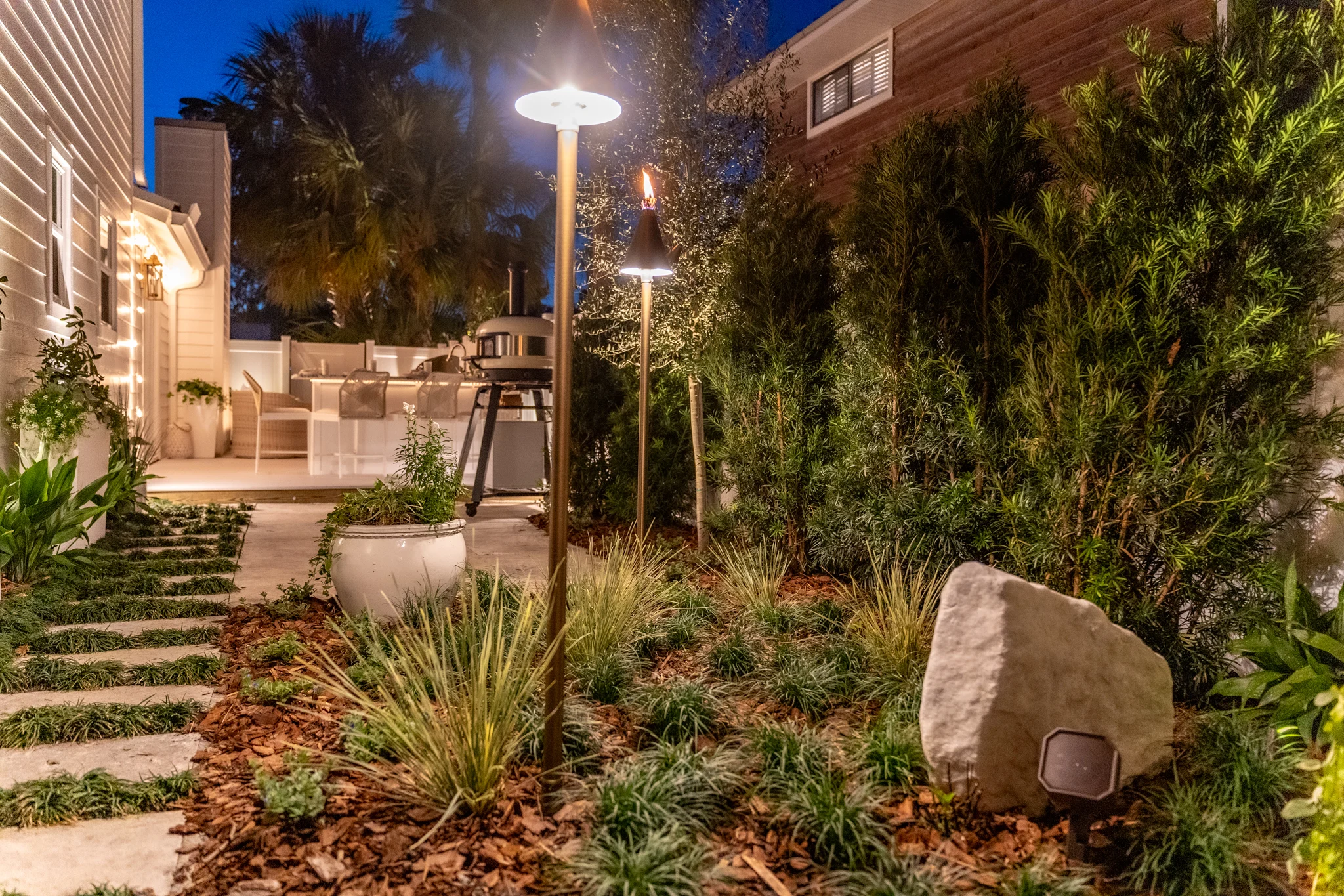 Pergola Patio Escape Pergola patio design in Atlantic Beach with pavers, greenery, and entertainment features