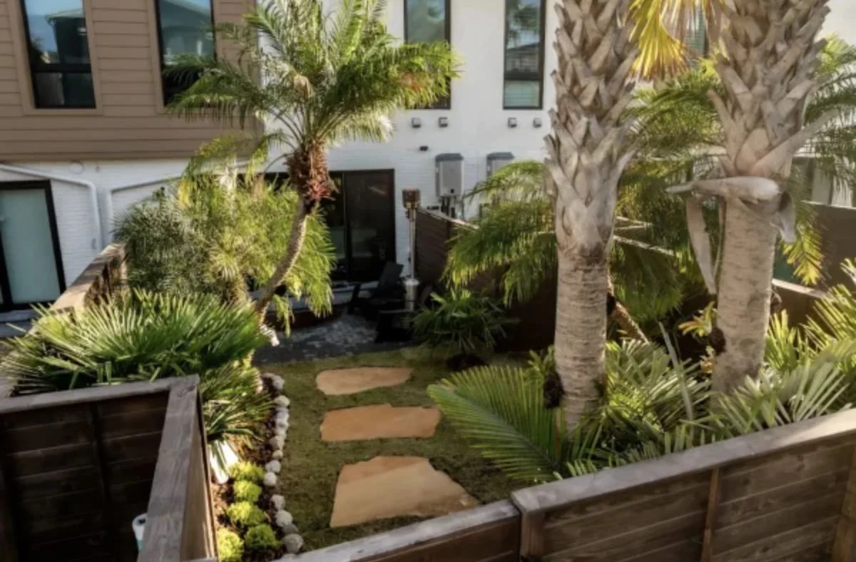 Welcoming landscape design with natural elements, water features, and sustainable practices for an Atlantic Beach home