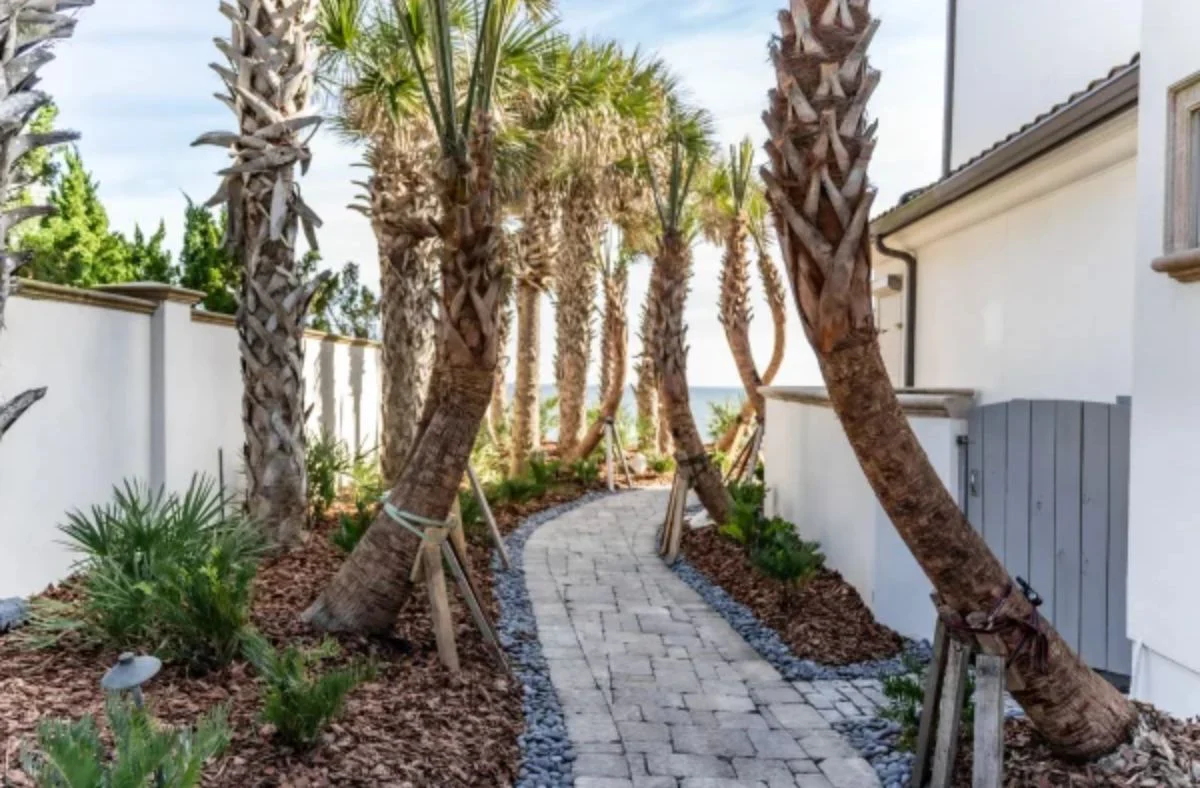 Outdoor living spaces completed during a custom landscaping project using natural elements for a Duval County coastal home